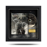 Framed 'Expedition 77' game disc with cover on a white background