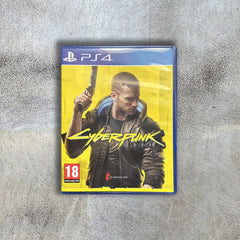 PlayStation 4 game case for 'Cyberpunk 2077' on a textured gray surface PlayStation 4 game case for 'Cyberpunk 2077' on a textured gray surface