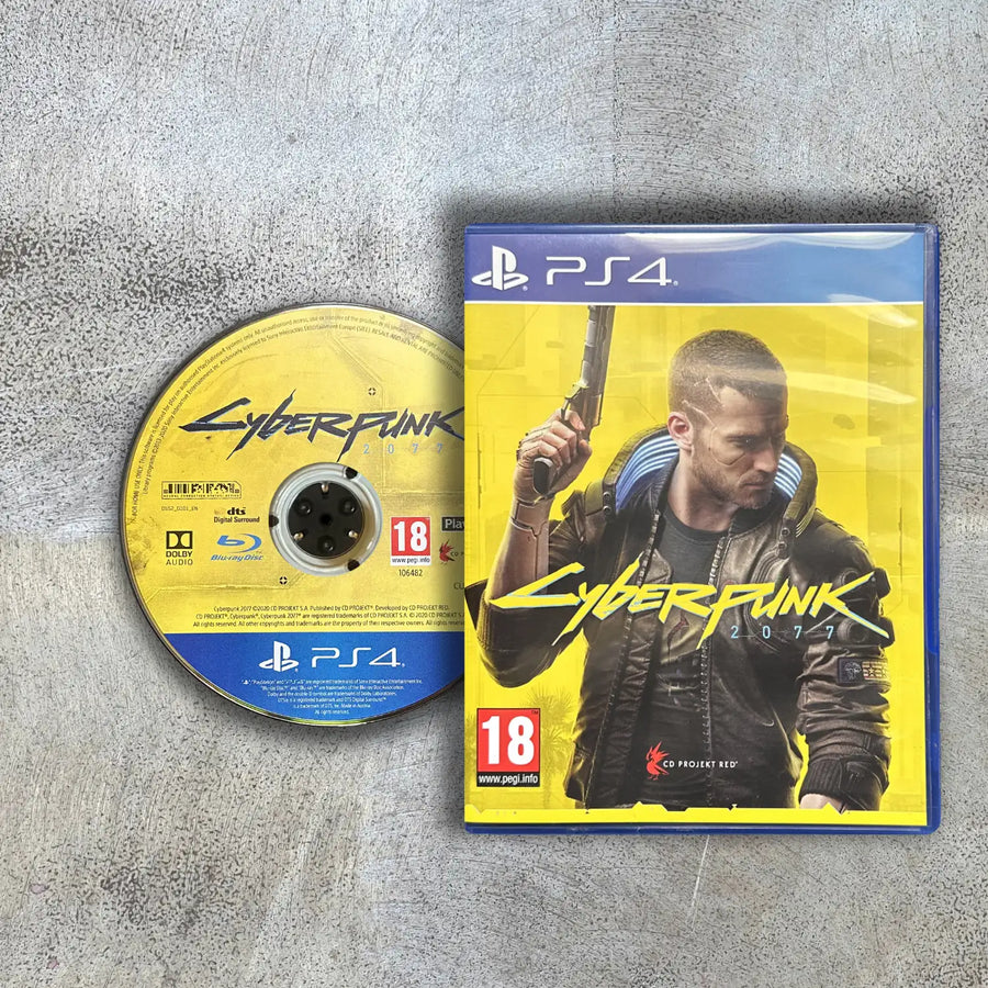 Cyberpunk 2077 game case and disc on a gray surface with disc to the left