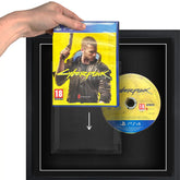 A person holding a Playstation 4 (PS4) video games sliding it into a plastic protective case, in a frame.