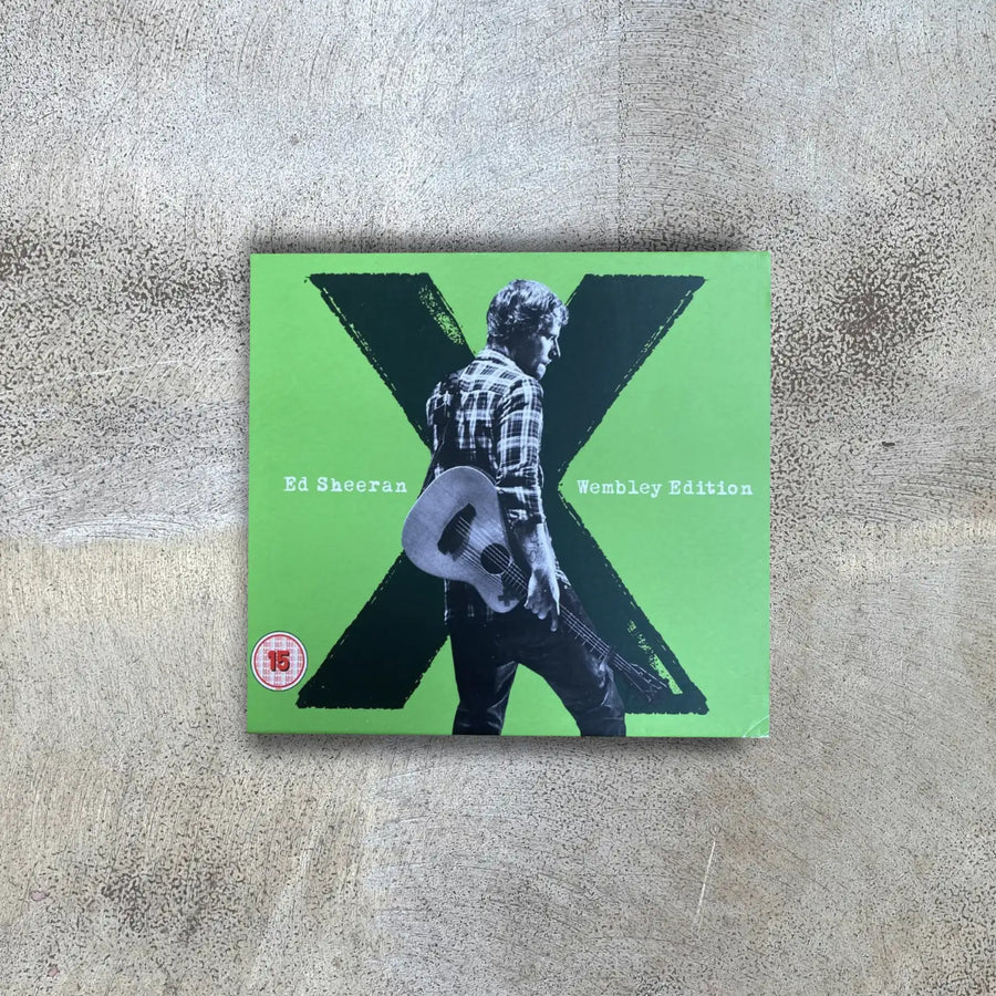 CD cover of Ed Sheeran's 'X' album on a textured surface