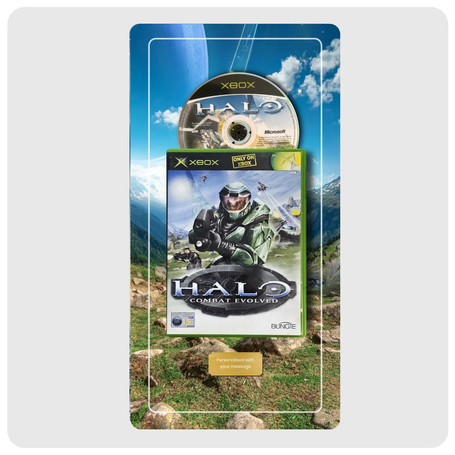 Halo Combat Evolved video game case with a matching game disc displayed in front of a scenic mountain backdrop, centered on a light gray background.