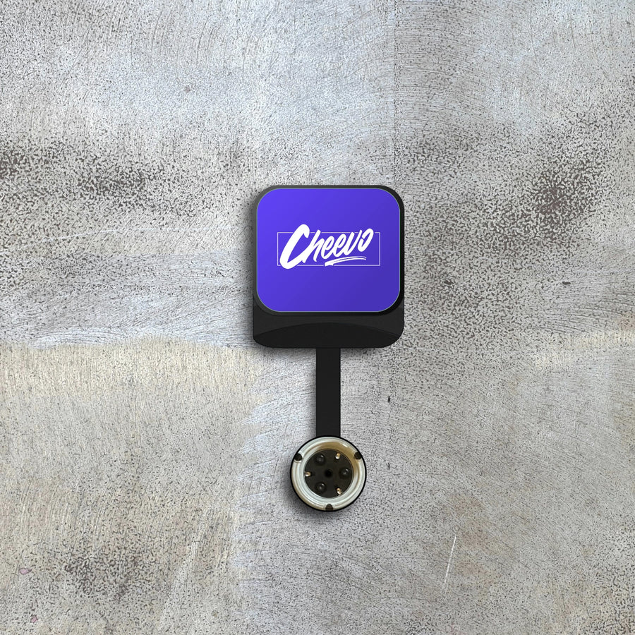 Square device with a purple screen displaying 'Cheevo' logo on a textured gray background