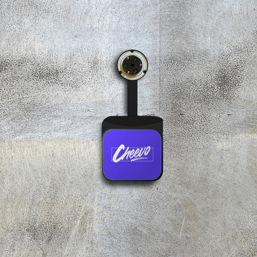 A device to be used on a wall with 'Cheevo' logo on a textured gray surface