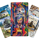 Three game-themed card-style covers fanned out against a white background: a blue Xbox Halo card on the left, a colourful John Wick: Chapter 4 card in the center, and a PS5 Ghost of Yotei plate on the right.
