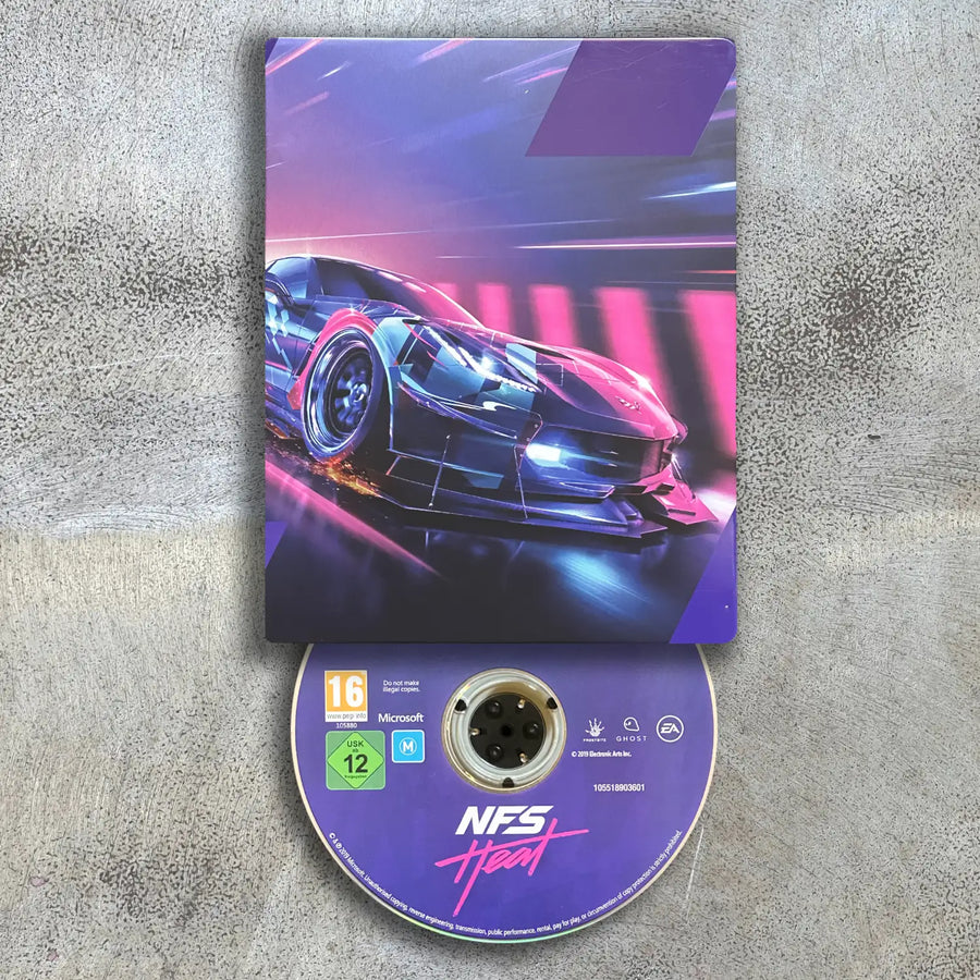 Steelbook game disc and cover for 'Need for Speed: Heat' on Xbox One on a textured surface