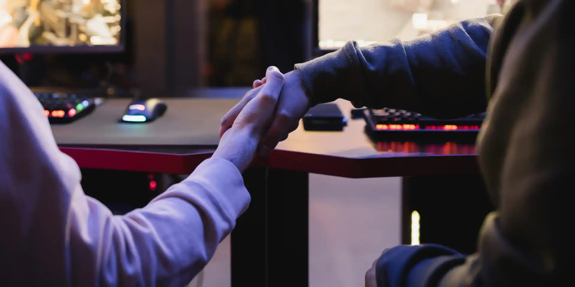 Two people shaking hands whilst building a partnership together