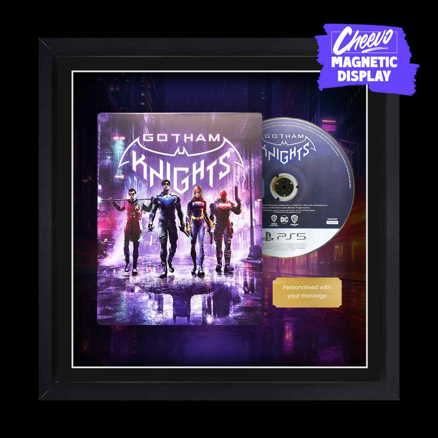 Batman Gotham Knights Playstation 5 (PS5) steelbook on display inside of a picture frame. The game case and disc sit next to each other alongside a gold metal plaque.