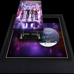Batman Gotham Knights steelbook being added to a magnetic bracket within a picture frame. The game disc is inside and to the side of the case.