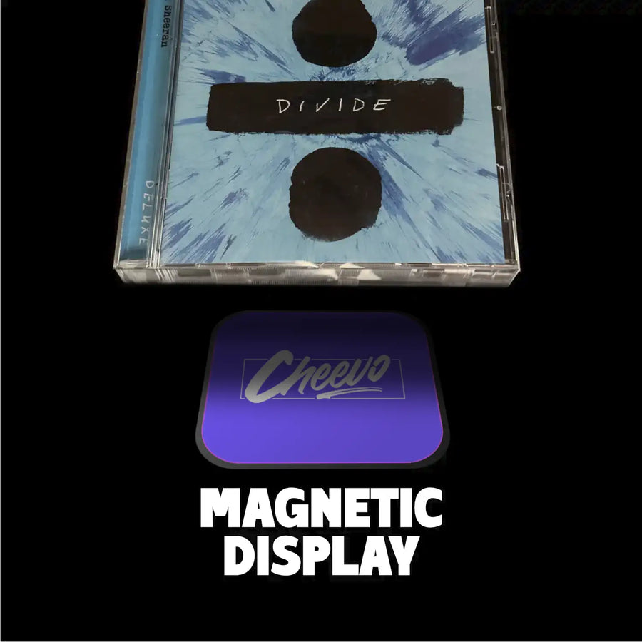 CD jewelled case and disc with 'Divide' text and a purple magnetic display labeled 'Cheevo' on a black background.