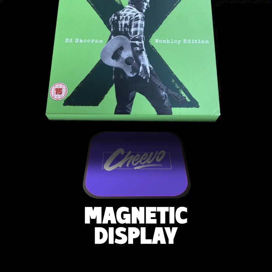 Green album in a cardboard sleeve box set with a person holding a guitar, featuring 'Cheevo' magnetic display on a black background.