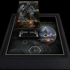 Ender's Game steelbook being added to a frame to be displayed on the wall. The frame also includes the movie disc next to the case.
