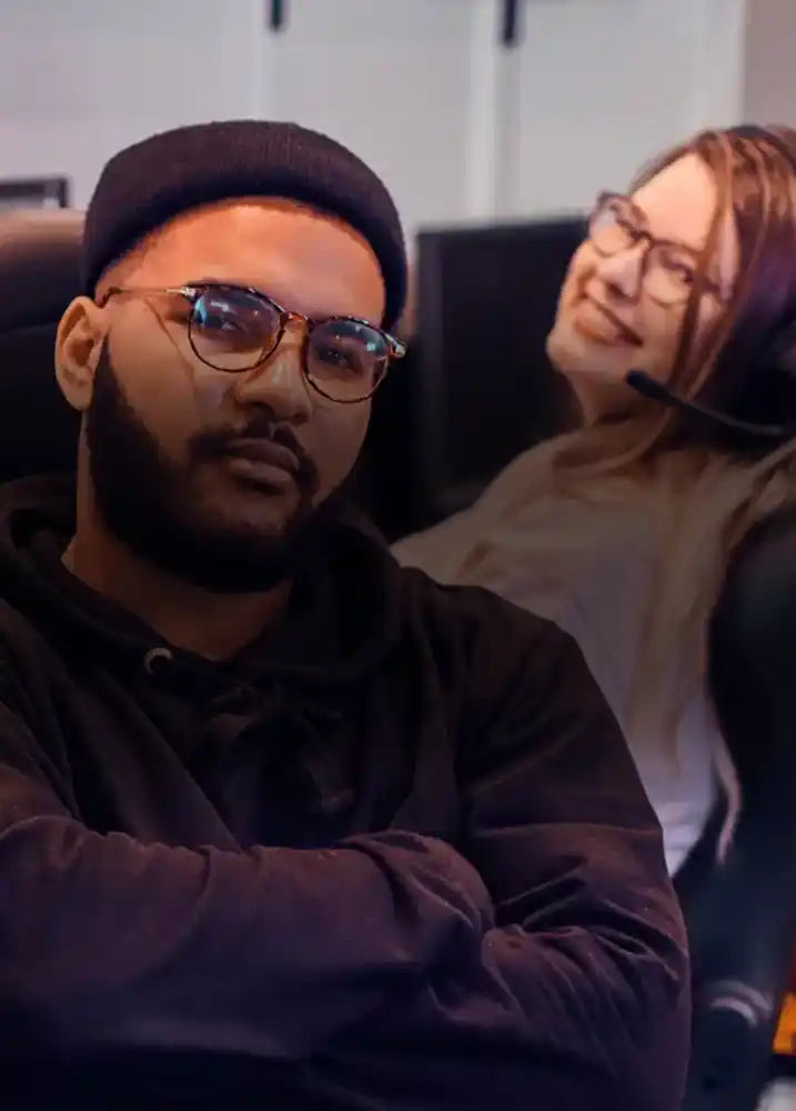 Two game developers posing for the camera, smiling, ready to assist with the next video game project