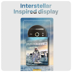 An artwork display featuring an Interstellar steelbook Blu-ray case with a matching disc mounted above it, set against a stylized space-and-ocean artwork. Large text at the top reads 'Interstellar Inspired display.