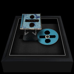 Frame showing an album case and CD next to each other being prepared for display