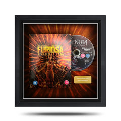 Framed DVD cover of 'Furiosa: A Mad Max Saga' with a disc on a white background
