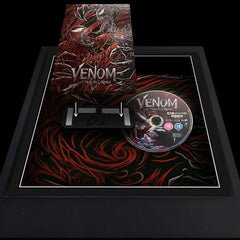 A frame displaying a Venom movie case and disc steelbook with printed background