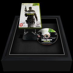 Adding an xbox 360 game to a magnetic attachment to be framed for display.