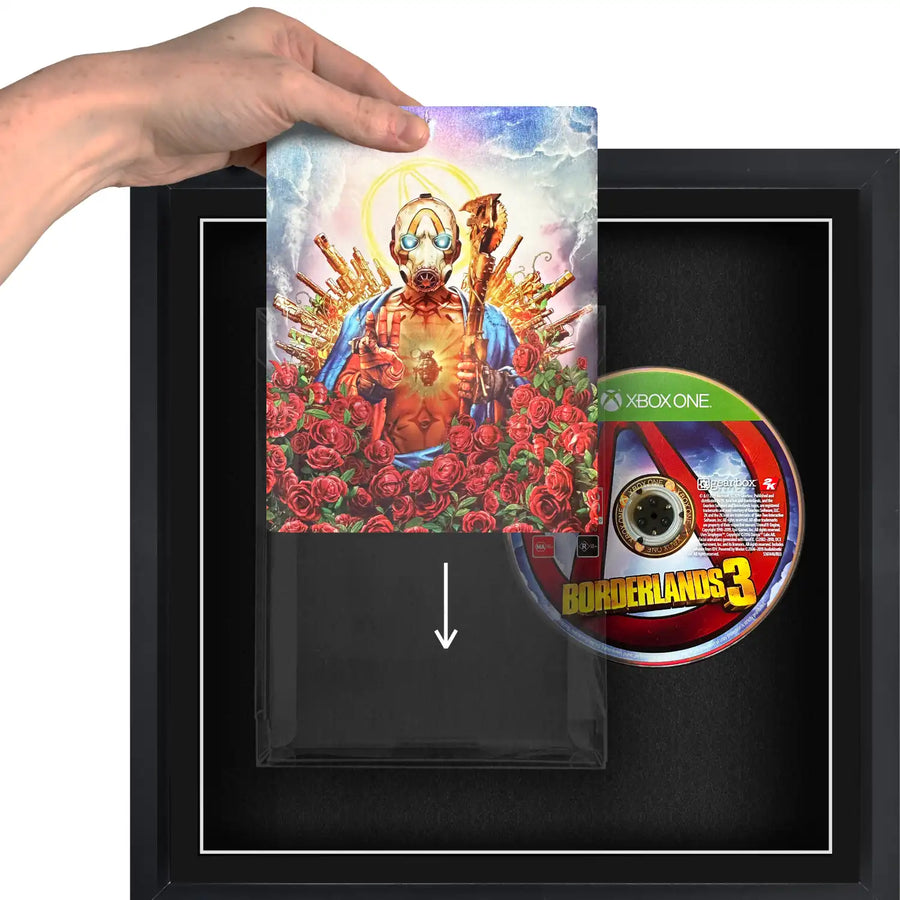 A person holding a Xbox One video games sliding it into a plastic protective case, in a frame.