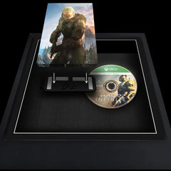 Xbox Series X video game steelbook being added to a frame to be displayed alongside the disc.