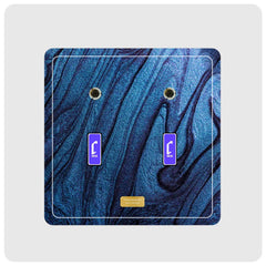 A square double gaming plate featuring a dark blue and black marbled pattern, with two purple box with Cheevo logo and a small gold plate at the bottom, shown on a light gray background.