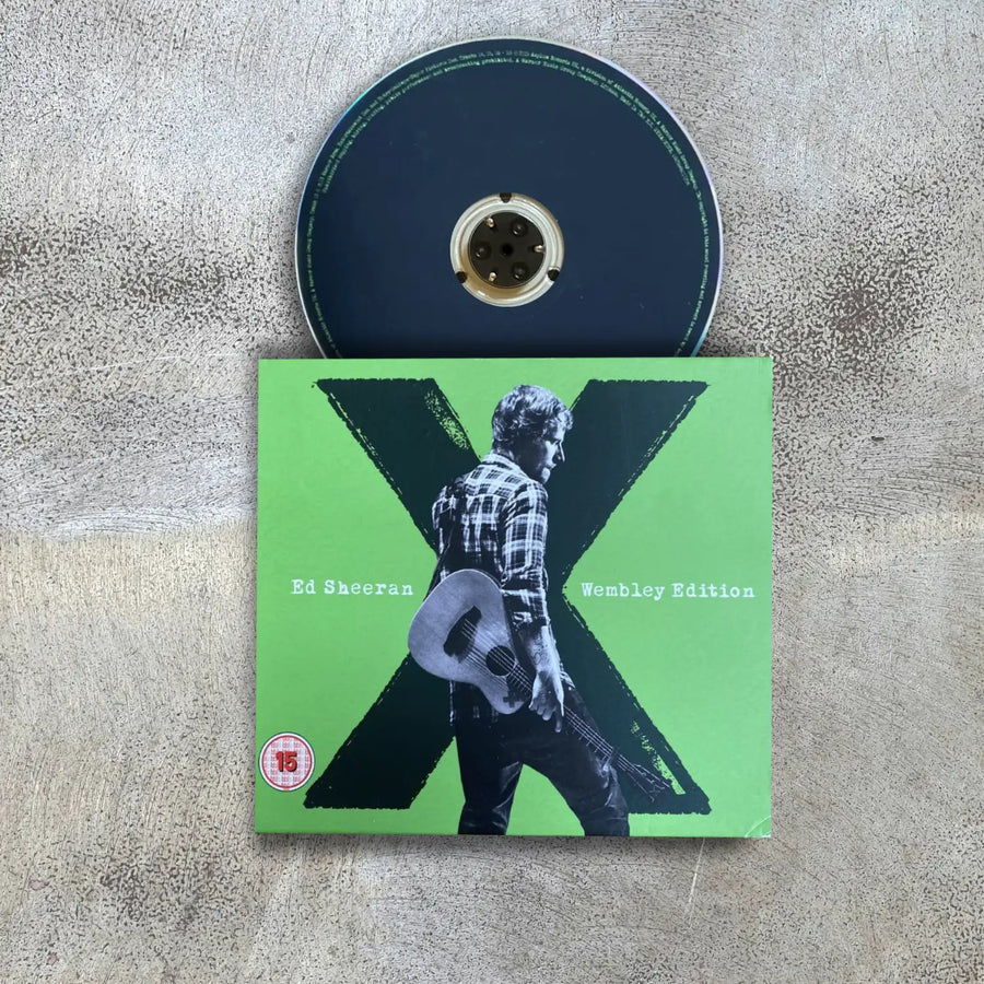 CD and cover of Ed Sheeran's 'X' album on a textured surface