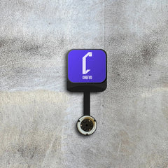 Square device with a purple screen displaying 'Cheevo' logo on a textured gray background