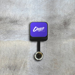 Square device with a purple screen displaying 'Cheevo' logo on a textured gray background