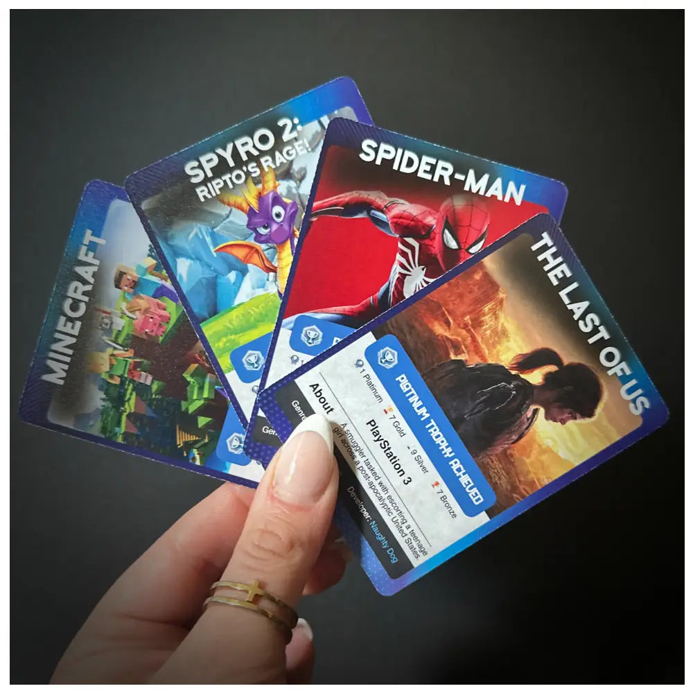 Four Playstation platinum trophy cards for 'Minecraft', 'Spyro 2: Ripto's Rage', 'Spider-Man', and 'The Last of Us', printed on both sides, awarding gamers for unlocking the platinum trophy