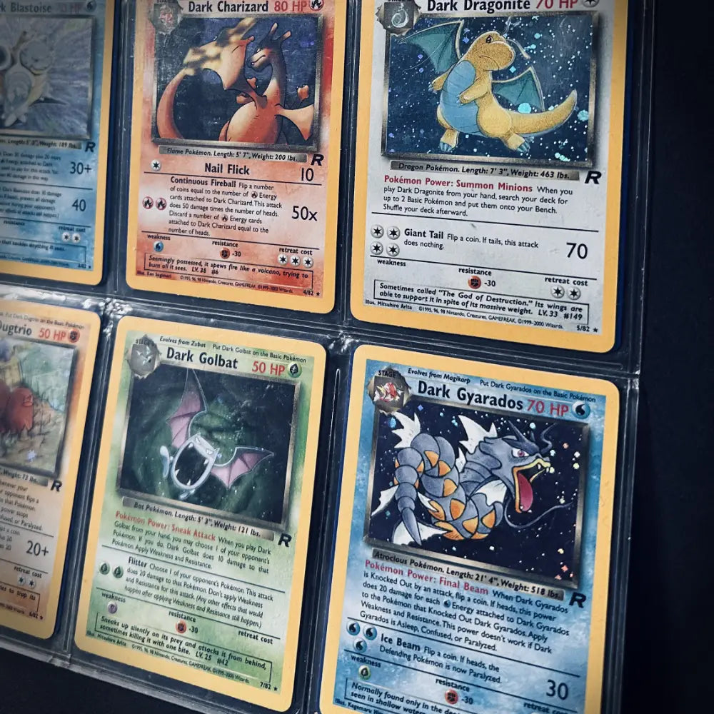 Six shiny variant Pokemon cards including 'Charizard', 'Dragonite', 'Golbat', and 'Gyarados' in a protective wallet