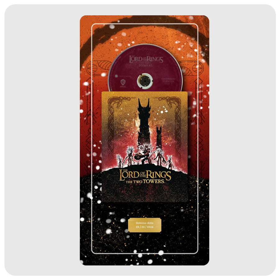 A Lord of the Rings: The Two Towers 10-year diamond anniversary DVD box set displayed on a light gray background. The set features a red and black outer sleeve with white speckled details, a gold inner sleeve with a black silhouette of the Tower of Power, a purple jewel case containing the CD, and a gold plaque at the bottom.