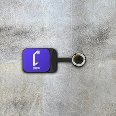 Video game wall display in purple with 'Cheevo' logo on a textured gray surface